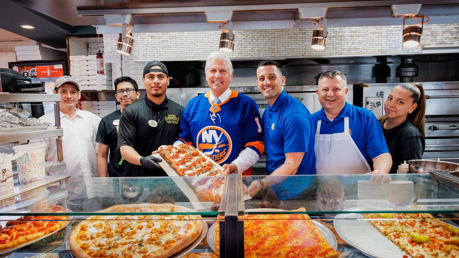 Bruce Blakeman smiles at local pizzeria with staff
