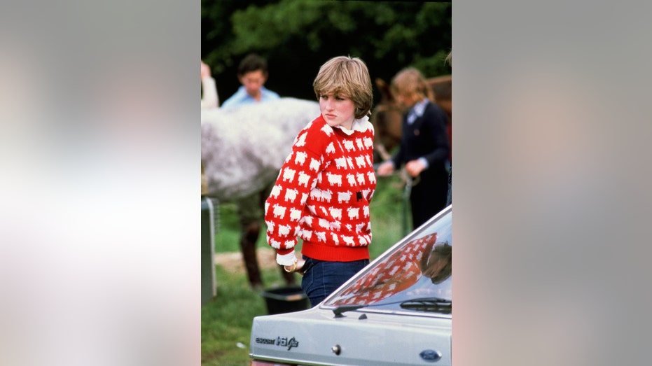 Princess Diana looking somber while wearing her black sheep sweater