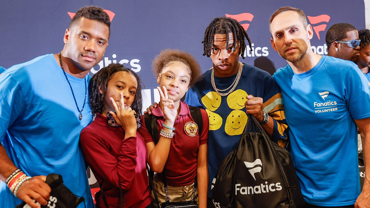 Meek Mill, Lil’ Baby, Eli Manning, Russell Wilson and more were on hand at Frederick Douglass Academy in Harlem Tuesday for Fanatics CEO Michael Rubin’s inaugural Merch Madness Fan Gear Giveaway. 