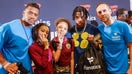 Fanatics CEO Michael Rubin, rapper Lil&apos; Baby and Denver Broncos quarterback Russell Wilson pose with kids from Frederick Douglass Academy in Harlem during Merch Madness inaugural event on June 27, 2023. 