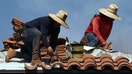 PHOENIX, ARIZONA - JULY 26: People work on the roof of a church amid the citys worst heat wave on record on July 26, 2023 in Phoenix, Arizona. While Phoenix endures periods of extreme heat every year, today is predicted to mark the 27th straight day of temperatures reaching 110 degrees or higher, a new record amid a long duration heat wave in the Southwest. Extreme heat kills more people than hurricanes, floods and tornadoes combined in an average year in the U.S. (Photo by Mario Tama/Getty Images)
