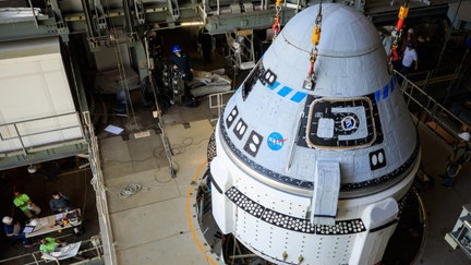 The Boeing CST-100 Starliner spacecraft is lifted at the Vertical Integration Facility at Space Launch Complex-41 at Cape Canaveral Space Force Station in Florida on May 4, 2022, ahead of its second Orbital Flight Test (OFT-2) to the International Space Station for NASA's Commercial Crew Program.

